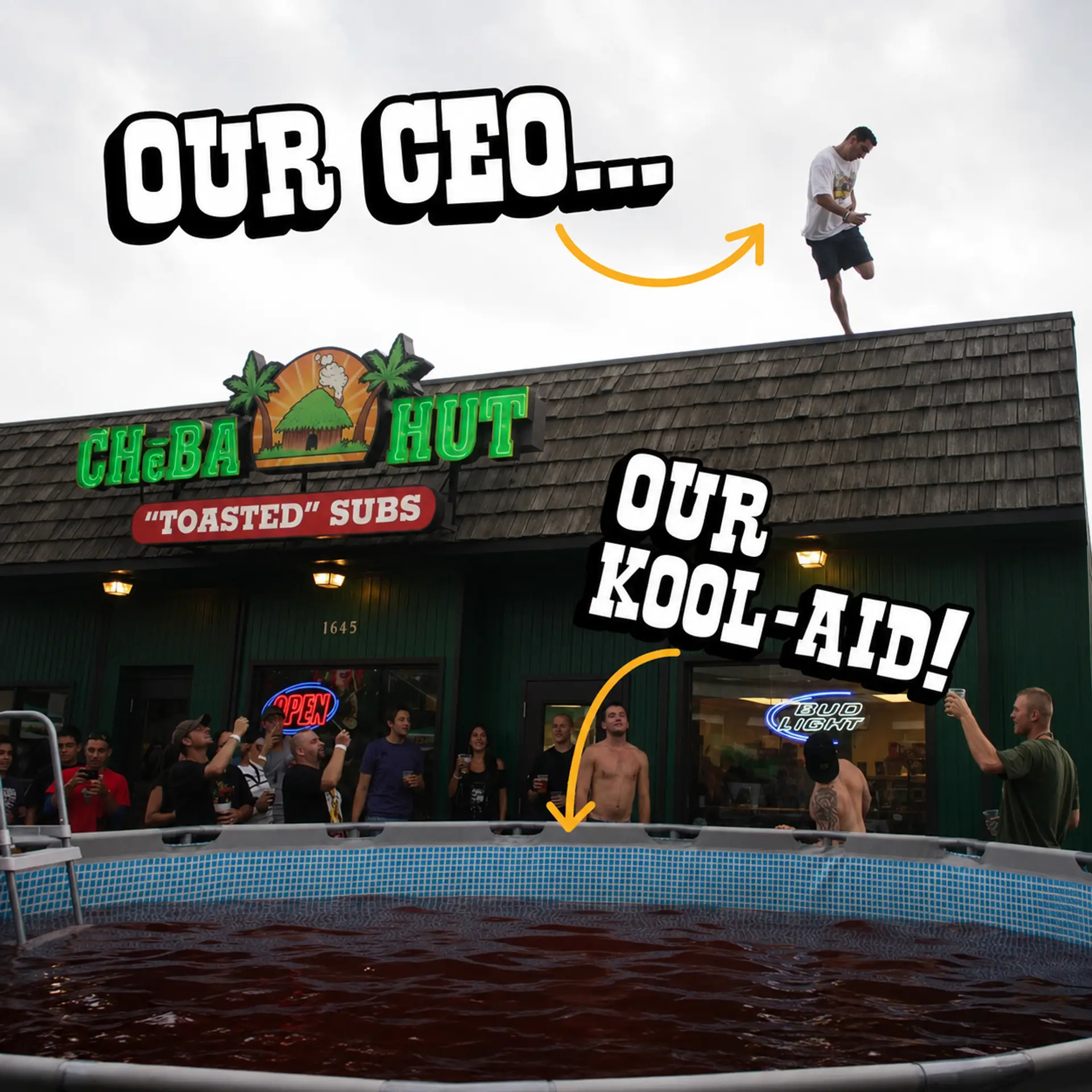 A man stands on the roof of a Cheba Hut "Toasted" Subs shop above a cheering crowd and an above-ground pool full of red Kool-Aid. Hand-drawn captions with arrows: "Our CEO..." points to the man on the roof, and "Our Kool-Aid!" points to the pool.