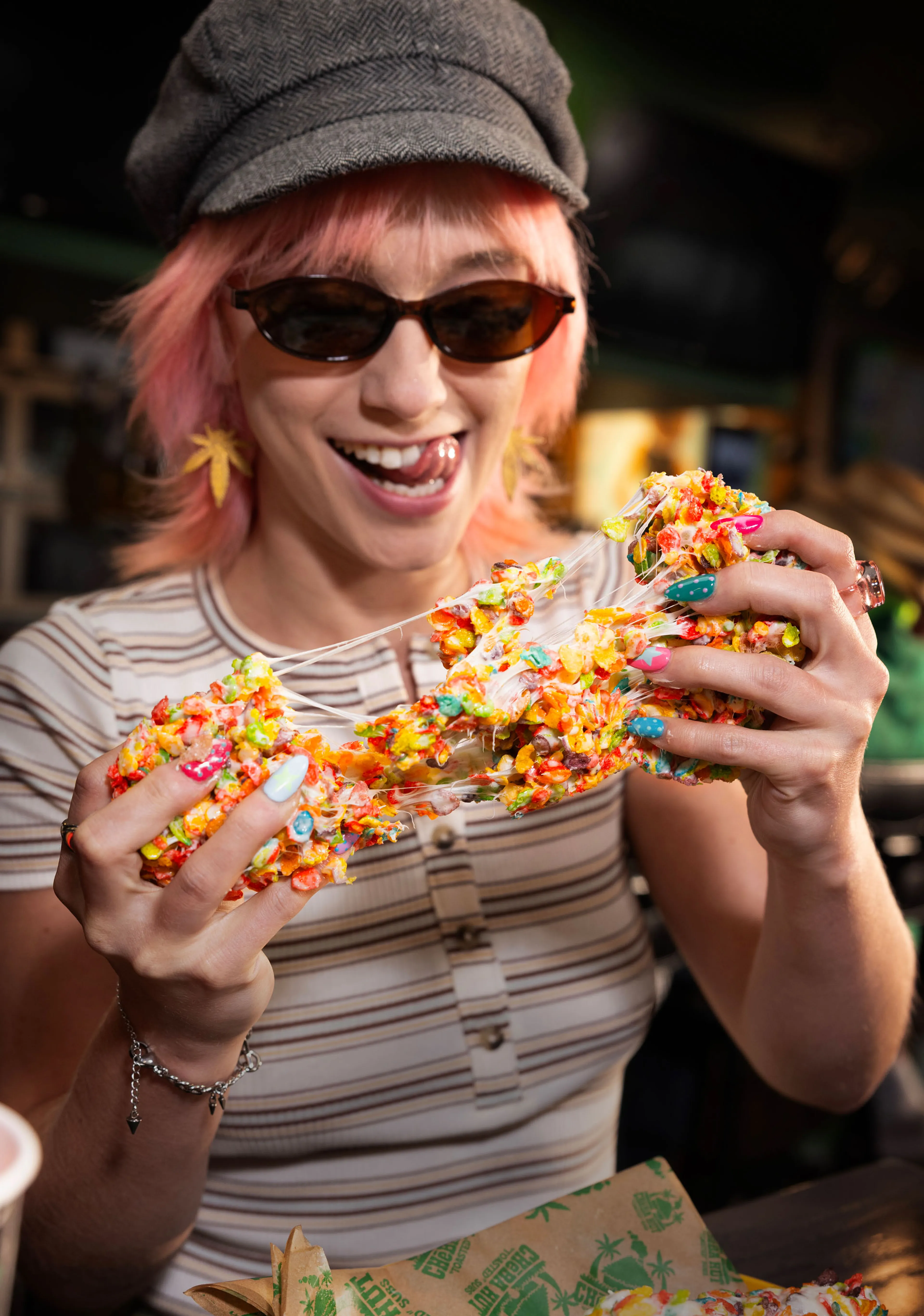 Person pulling apart a colorful crispy rice treat