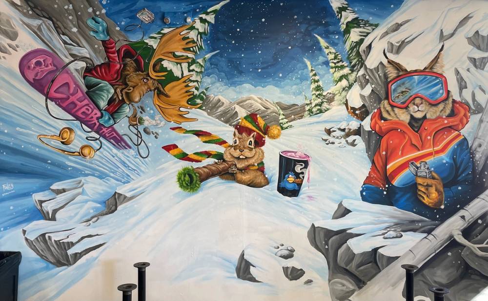 Mural of a moose, squirrel and rabbit lighting up on a ski mountain