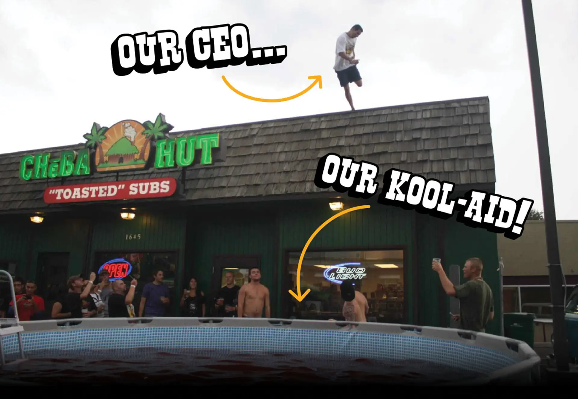 A man stands on the roof of a Cheba Hut "Toasted" Subs shop above a cheering crowd and an above-ground pool full of red Kool-Aid. Hand-drawn captions with arrows: "Our CEO..." points to the man on the roof, and "Our Kool-Aid!" points to the pool.